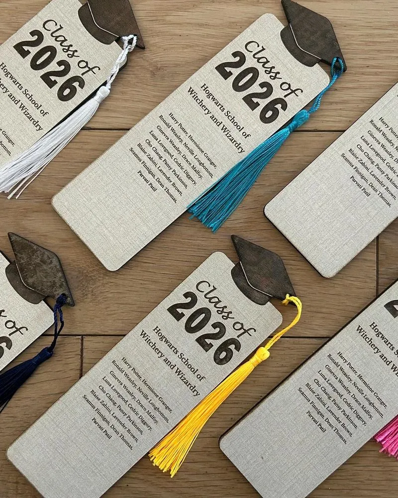 Stack of wooden graduation bookmarks customized with different school emblems